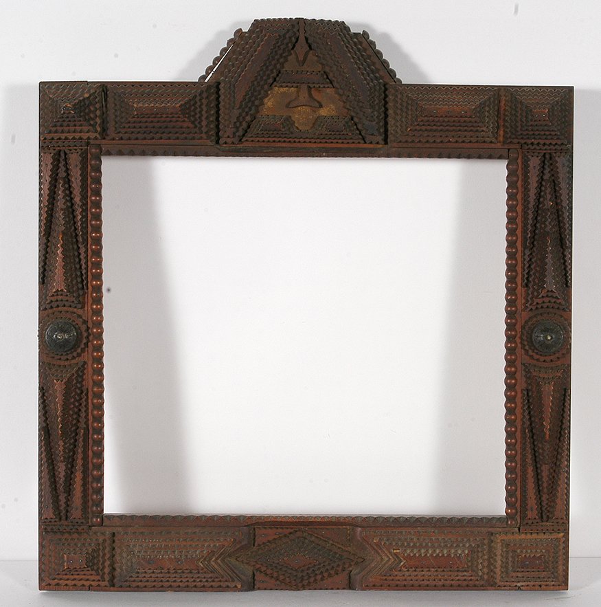Tramp Art Multi-Design & Shape Frame.: Tramp Art Multi-Design & Shape Frame. Chip-carved and varnished wood. Minor chip, otherwise excellent condition. 20” x 23” x 3”. Est. $300-500. Ship: $65