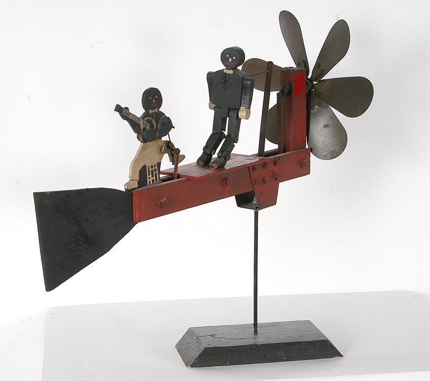 Af-Am Banjo Player & Dancer Whirligig.: Anonymous Whirligig. Af-Am Stylized Banjo Player & Dancer. Not signed or dated. Carved and paitned wood and metal blades and gears. Great condition. 25”h x 28” x 6”. Est. $100-200. Ship: $100