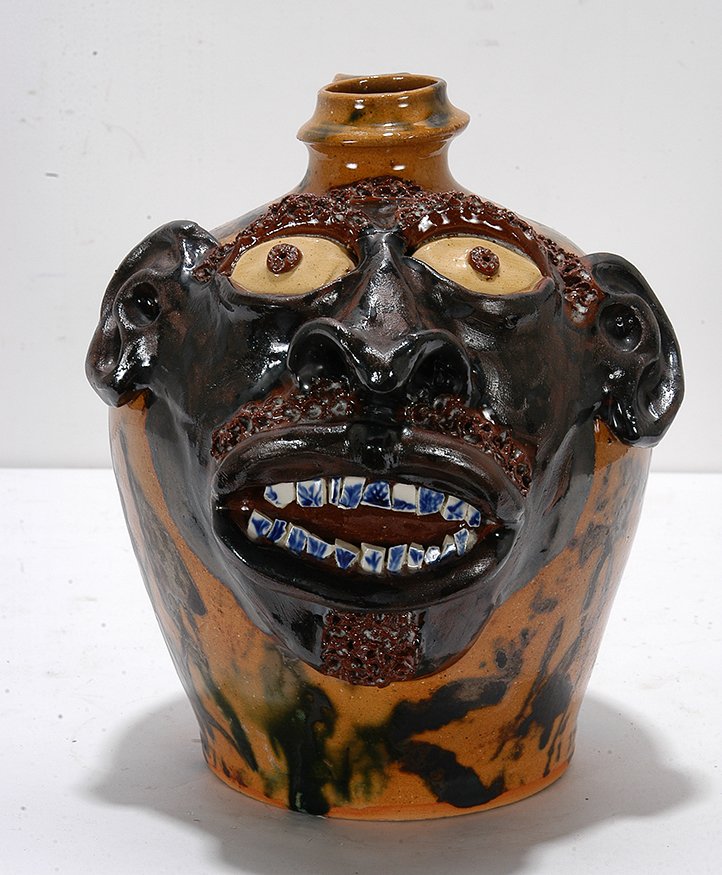 Billy Ray Hussey. Face Jug With Flow Blue Teeth.: Billy Ray Hussey. Dark Face Jug With Flow Blue China Teeth. Initialed. Multi-colored glazed pottery. Mint condition. 9”h. Est. $500-800. Ship: $45