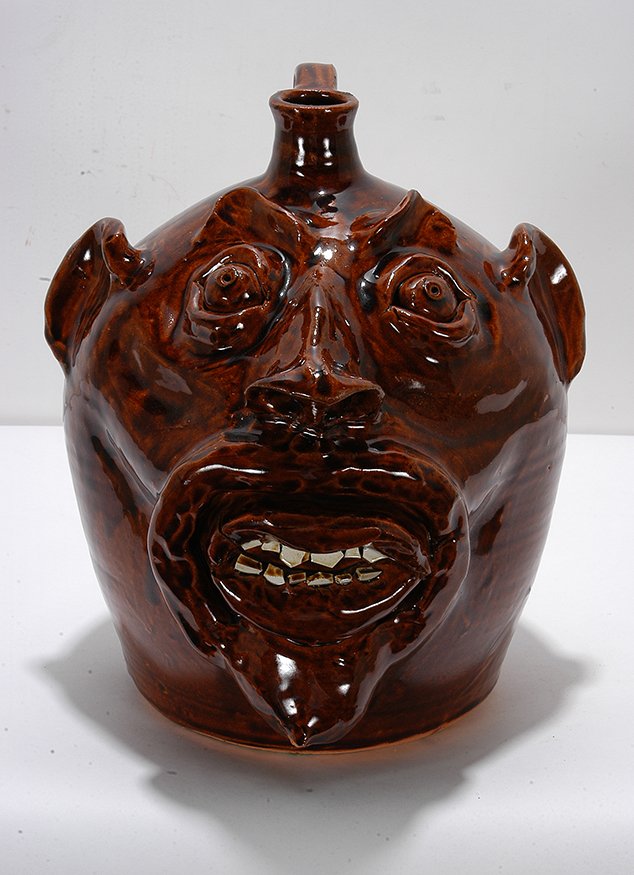 Robert Brown. Large Face Jug With Goatee.: Robert Brown. Large Face Jug With Goatee. 1986. Signed and dated. Minor chip on goatee, otherwise great condition. Traditional brown glaze. 10”h. Est. $200-400. Ship: $75