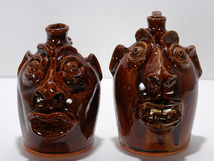 Robert Brown. Pair of Medium Size Face Jugs.: Robert Brown. Pair of Medium Size Face Jugs. 1985-86. Signed and dated. Traditional glaze. One has nude woman for handle. Mint condition. 8.5” h. Est. $200-400. Ship: $75