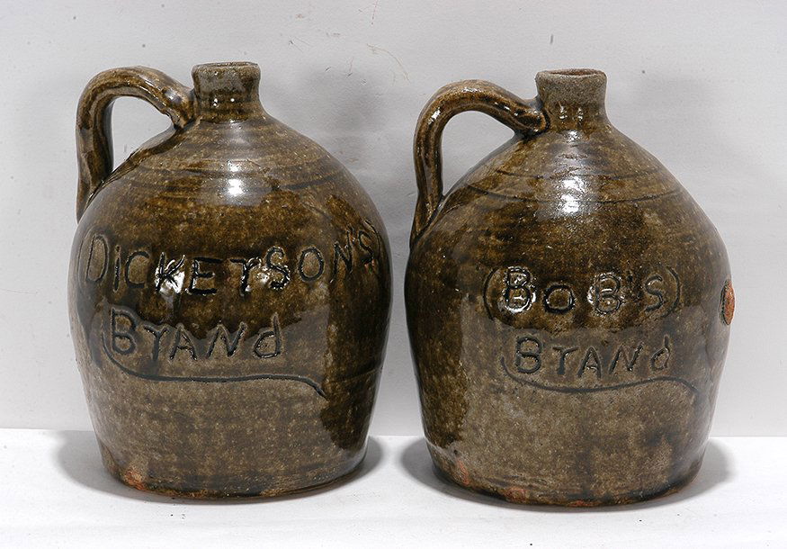 Cheever Meaders. Bob’s & Dickerson’s Whiskey Jugs.: Cheever Meaders. Bob’s Brand & Dickerson’s Brand Matching Whiskey Jugs. One is initialed, “C.M.” on bottom. Both are inscribed on side and matching glaze. Average size is 7”h. One has chip o