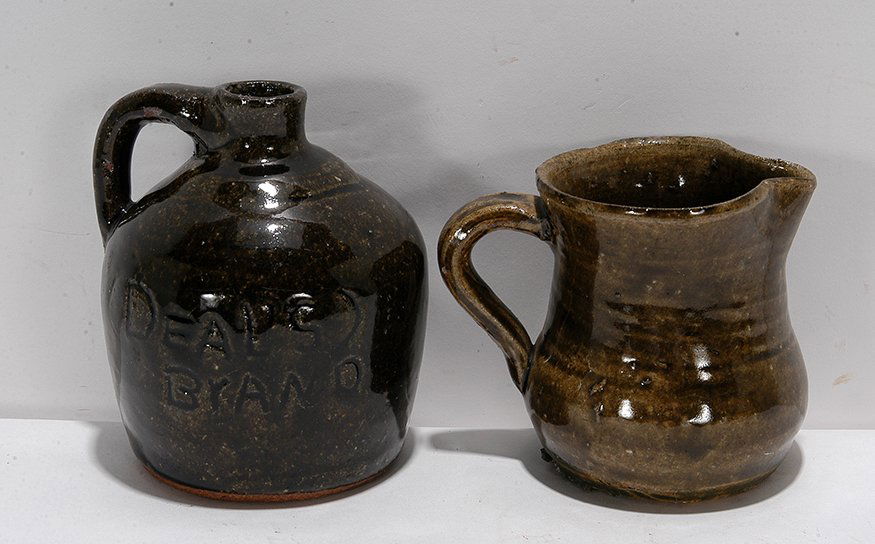 Cheever Meaders (attrib). Creamer & Whiskey Jug.: Cheever Meaders (attributed). Small Creamer & Whiskey Jug. Jug is titled, “Deal’s Brand.” Not signed, jug is dated 1963 on bottom. Both are light and dark ash glaze. Mint condition. 5”h. Prove