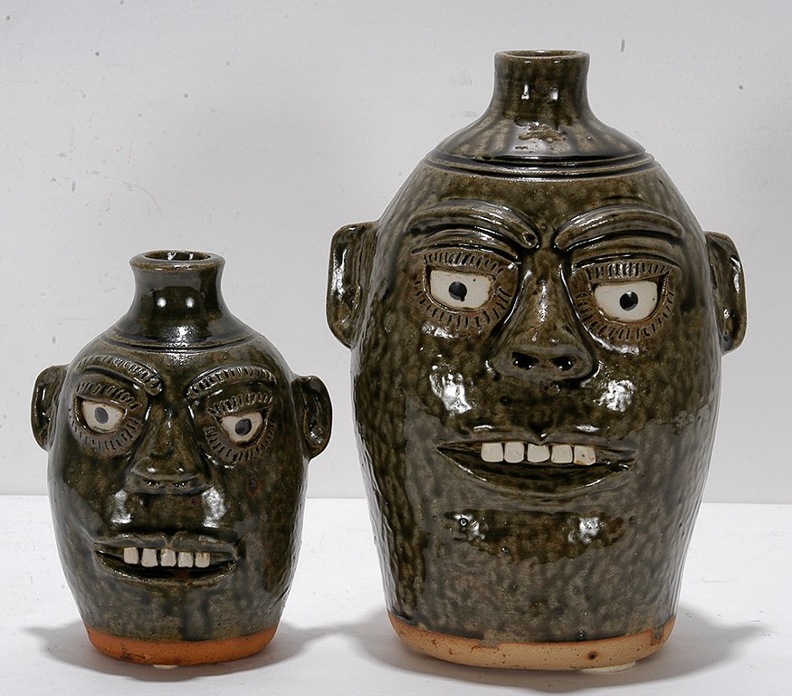 A.G. Meaders. Father And Son Face Jugs.: A.G. Meaders. Father And Son Face Jugs. c. 1980’s. Signed. Great tobacco-spit glaze. Mint condition. Tallest is 10” h. Est. $300-500. Ship: $6