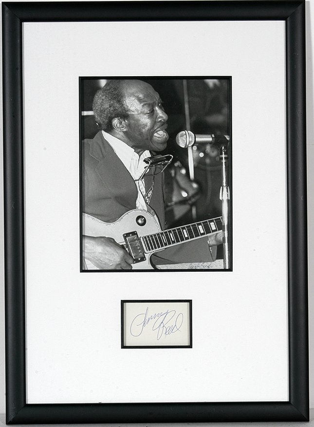 Jimmy Reed . Photo With Signature Card.: Jimmy Reed (1925-1976). Photo With Signature Card. Major impact in the field of electric blues and heavily influenced Elvis Pressley and the Rolling Stones. Photo is signed by photographer and is 7”