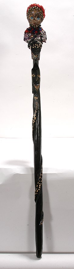 Pierrot Barra. Voodoo Cane.: Pierrot Barra. Voodoo Cane. Not signed. Carved and painted wooden stick with applied plastic baby doll head and sequins. Excellent condition. 41”h. Est. $200-300. Ship: $65