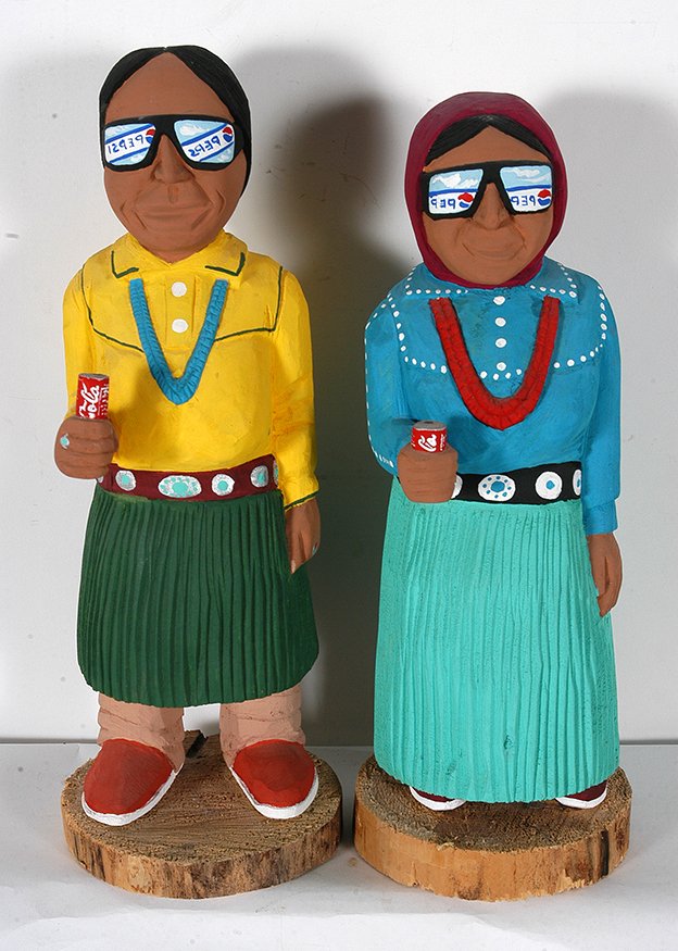 Harrison Juan. Navajo Figures With Coke Cans.: Harrison Juan. Navajo Figures With Coke Cans. Signed. Carved and painted wood. Excellent condition. 15.5” h. Provenance: The Private Collection of Chuck and Jan Rosenak. Est. $300-500. Ship: $55