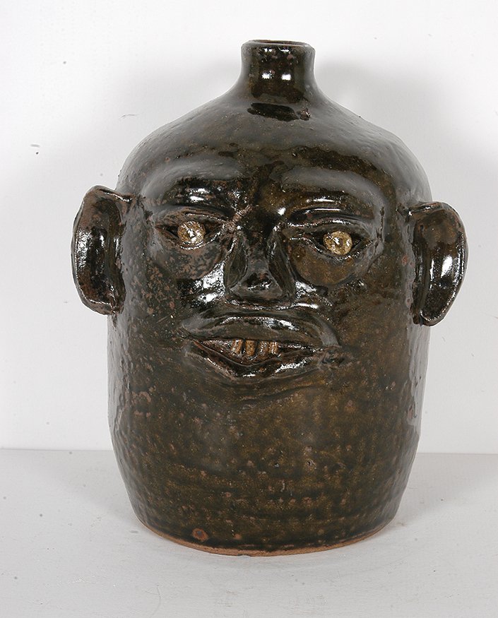 Reggie Meaders. Early Face Jug.: Reggie Meaders. Early Face Jug.Signed. Wood-fired with ash glaze. Mint condition. 8.5”h. Est. $400-600. Ship: $45