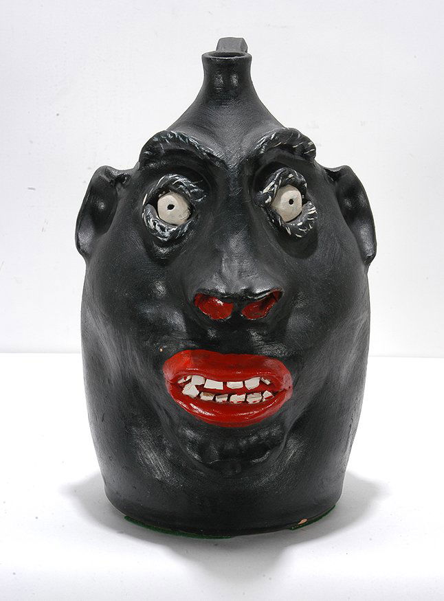 Robert Brown. NC State Fair Face Jug.: Robert Brown. NC State Fair Face Jug.1985. Signed and dated with script on base. Painted glaze. Mint condition. 13”h. Est. $300-500. Ship: $65