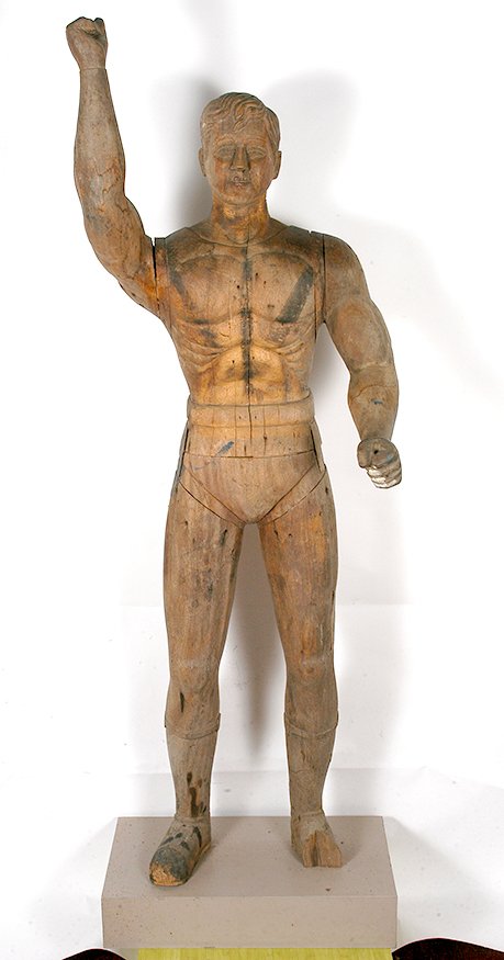 Life Size Superman. Man of Steel.: Unknown Artist. Superman. Man of Steel.Carved natural wood. 6 ft. 6 in. high. Some environmental wear and lost to half of foot, otherwise great condition. Est. $1,000-3,000. buyer is responsible for s