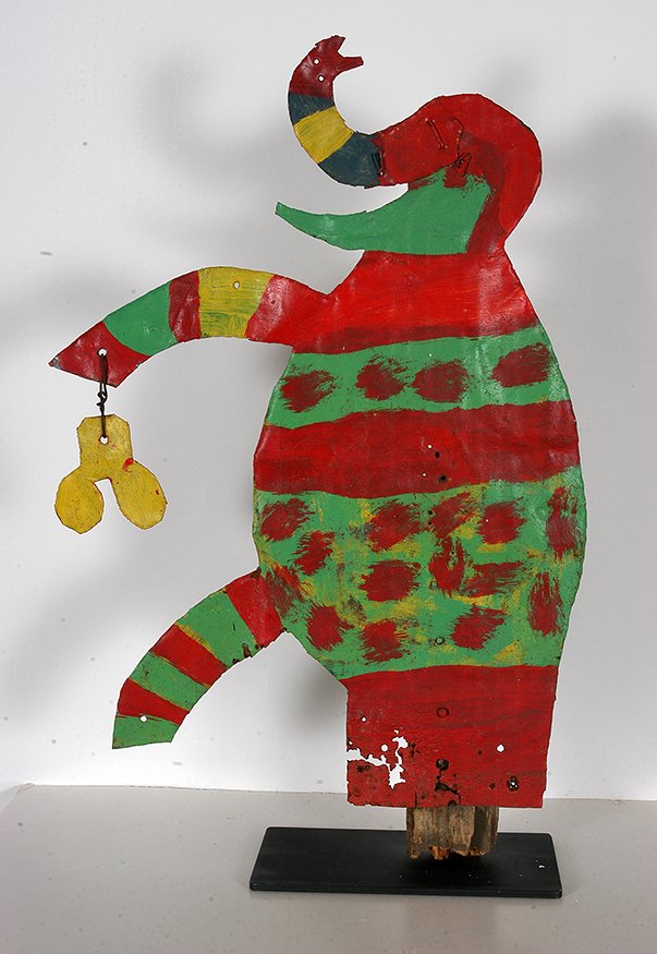 David Butler. Circus Elephant With Peanut.: David Butler. Circus Elephant With Peanut.Not signed. Cut out tin and paint attached to original wooden fence post. Some environmental loss on bottom, otherwise excellent condition. Size with display 