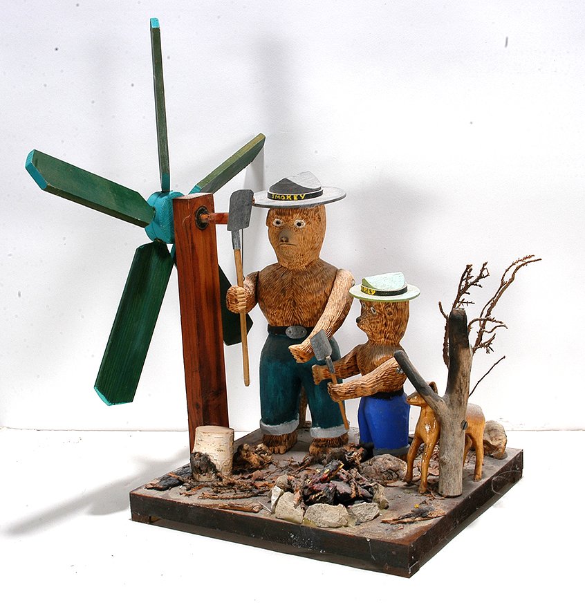John Bambic. Smokey The Bear Whirligig.: John Bambic. Smokey The Bear Whirligig. Signed. Carved and painted wood with mixed media. Excellent condition. 16” x 10” x 9”. Est. $400-600. Ship: $65