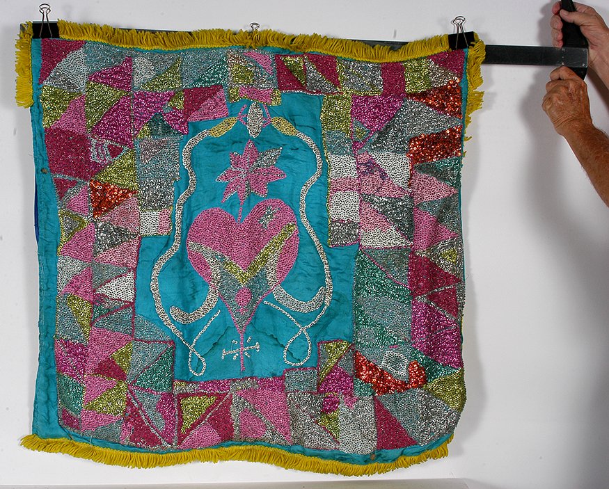 Haitian Voodoo Flag. Pink Heart w Snakes.: Haitian Voodoo Flag. Pink Heart With Snakes. Not signed. Hand sewn sequins and yarn backed to nylon and burlap. Water stain and some loss, otherwise fair condition. 34” x 34”. Est. $100-200. Ship: