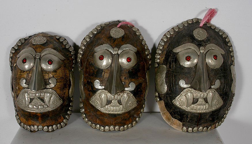 3 Turtle Shell Masks Decorated Tin Faces.: Unknown. Three Turtle Shell Masks Decorated Tin Faces. Some loss of metal and shell, otherwise good condition. Average size is 10”h. Est. $200-300. Ship: $55