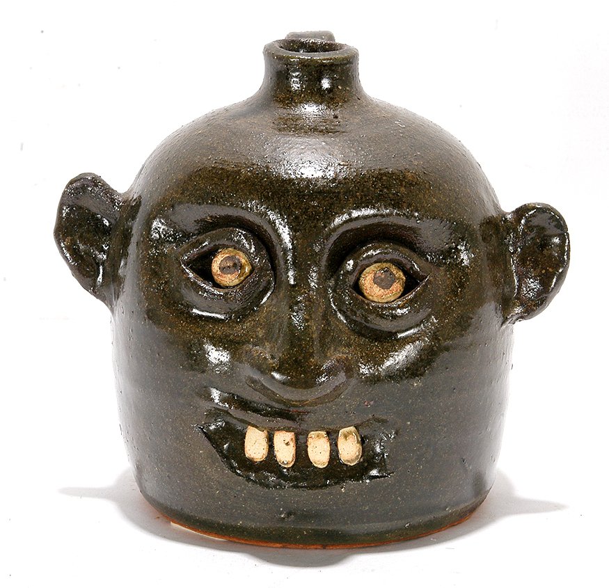 Reggie Meaders. 100 Years Of Meaders Pottery Face: Reggie Meaders. 100 Years Of Meaders Pottery Face Jug. 1992. Signed and written in script with 100 Anniversary. 6.5". Est. $300-500. Ship: $45
