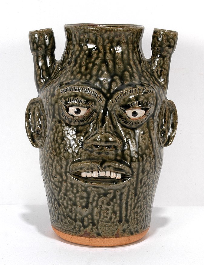 A.G. Meaders. Sorgum & Candelabra Face Jug.: A.G. Meaders. Sorgum and Candelabra Face Jug. Signed. Beautiful tobacco spit glaze. Mint condition. 10.5". Est. $400-600. Ship: $45