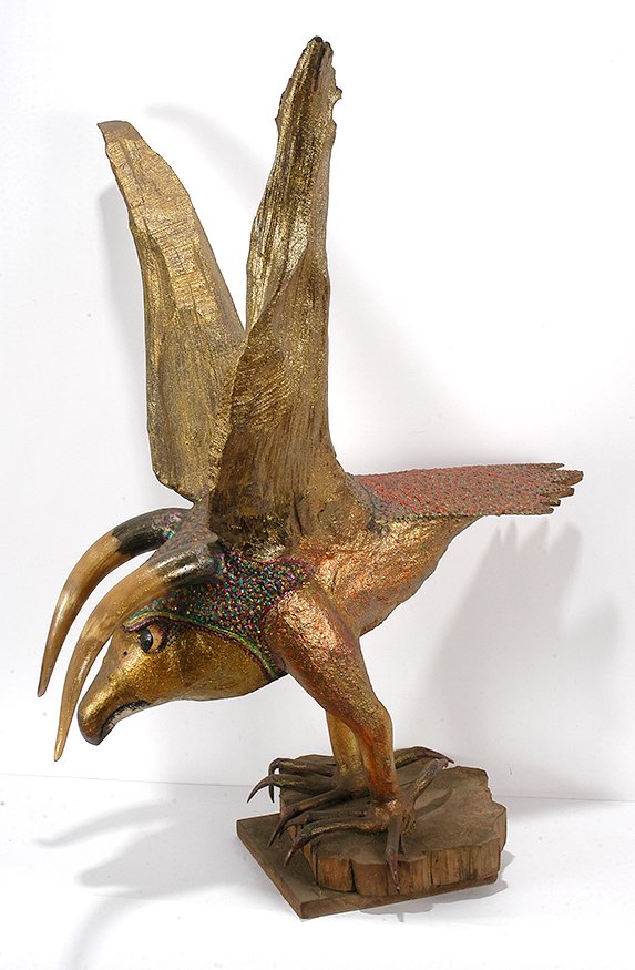O.L. Samuels. Horned Golden Eagle.: O.L. Samuels. Biblical Horned Golden Eagle Figure. Not signed. Carved wood with horns, paint and glitter. Excellent condition. Large work. 46”h x 32”x 34”. Est. $600-900. Buyer is responsible fo