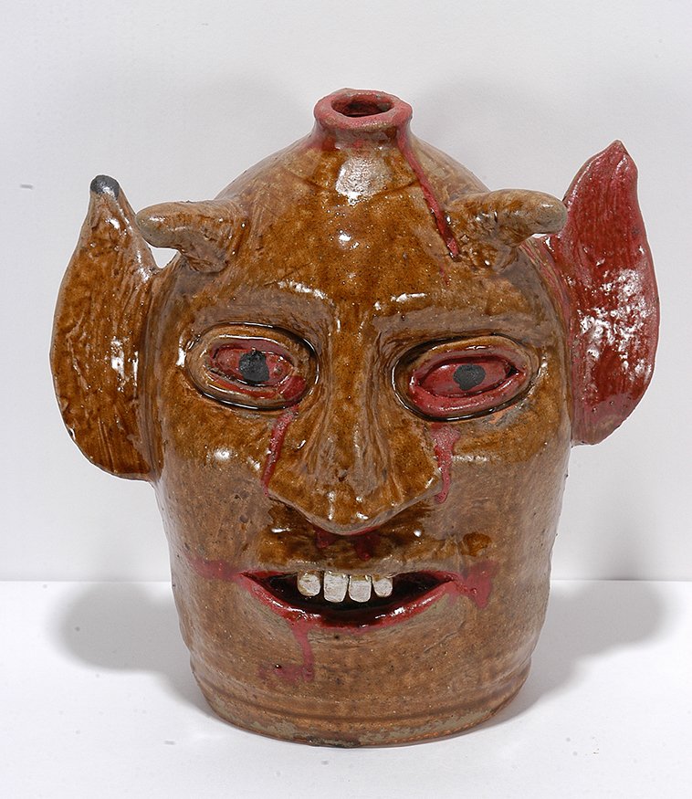 Reggie Meaders. Bloody Eyed Devil Face Jug.: Reggie Meaders. Bloody Eyed Devil Face Jug.2001. Signed and dated. Two color glaze. Mint condition. 10”h. Est. $400-600. Ship: $65