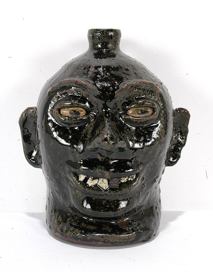 Lanier Meaders. Rock Tooth Face Jug With Dark Thick: Lanier Meaders. Rock Tooth Face Jug With Dark Thick Bubbled Glaze.c. 1970’s. Signed. Mint condition. 9.5”h. Est. $2,000-3,000. Ship: $55