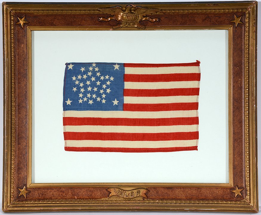 38 Great Star Pattern Flag.: 38 Great Star Pattern Flag. Print on cloth. Excellent condition. Image is 9.5” w x 6” h. Patriotic frame is 17” x 14”. Est. $400-500. Ship: $45