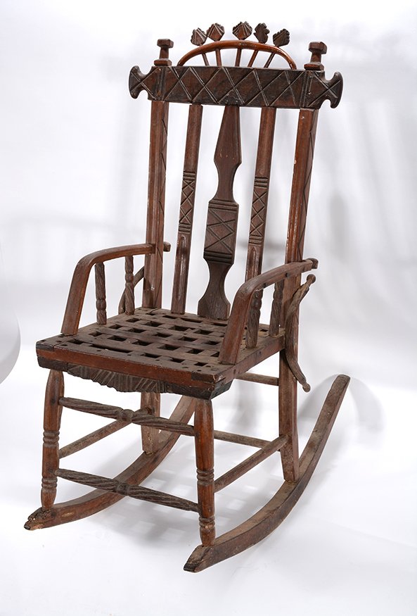 African American Child’s Rocking Chair.: African American Child’s Rocking Chair.Not signed. Carved wood with geometric patterns. Great early patina. Excellent condition. 35”h x 28” x 17.5”. Est. $1,000-1,500. Buyer is responsible for