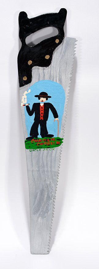 Uncle Jack Dey. Charlie Chaplin: Uncle Jack Dey. Charlie Chaplin.Signed and titled. Carved and painted wood. Excellent condition. 7” x 28” x 1”. Est. $300-500. Ship: $45