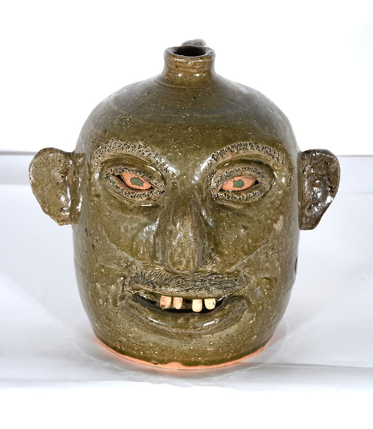 Reggie Meaders. Red Eye Experimental Glaze Face Jug. (1 of 3)