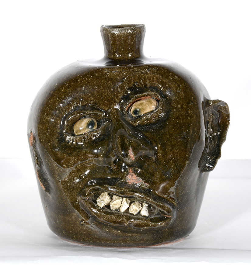 Lanier Meaders. Vango Face Jug.: Lanier Meaders. Vango Face Jug. c. 1960. Rock Teeth and glazed eyes. Kiln loss to ear and glaze on back of head, otherwise great condition. Rare example. 8.5”h. Est. $1,500-2,500. Ship: $55
