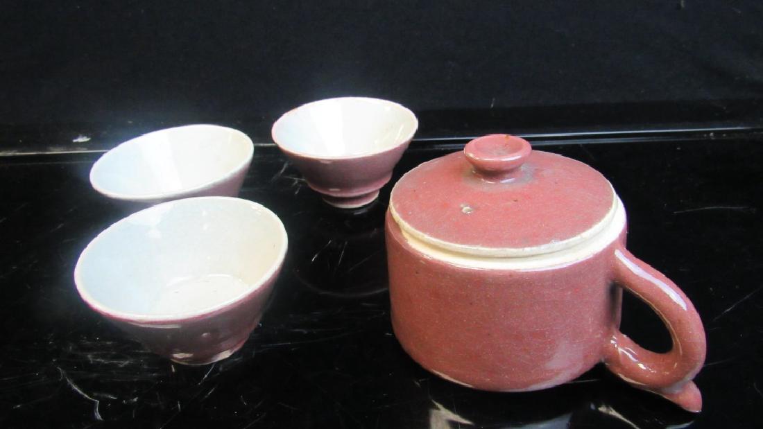 Glazed Porcelain Tea Set: Beautiful Qing Dynasty glazed porcelain tea set with pot, 4 cups and carrier. Muted rose color with white interiors. Great quality. Marked. Pot 3 1/4" dia x 2 1/2" Cups 2 5/8" dia x 1 1/2" tall Carrie