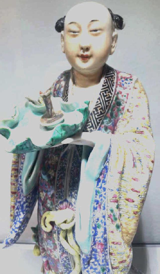 Qing Dynasty Famille Rose Figurine: Late QWing Dynasty Chinese Famille Rose figurine of a man in a colorful robe holding a bowl. 11" tall
