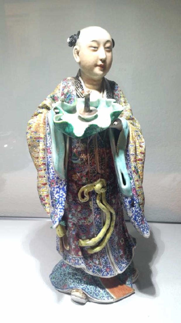 Qing Dynasty Famille Rose Figurine: Late QWing Dynasty Chinese Famille Rose figurine of a man in a colorful robe holding a bowl. 11" tall