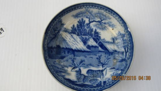 European Antique Blue and White Plate: An antique European blue and white plate; Features a painted scenic image of a woodland cottage with two deer; Decorative trim Diameter: 5 1/2"