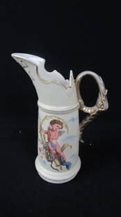 Victoria Carlsbad Austria Porcelain Pitcher: Ann antique Victoria Carlsbad Austria porcelain pitcher; Features a painted image of a cherub angel flying among the clouds; Handle is painted gold and shaped like an angel's wing; Fanciful gold