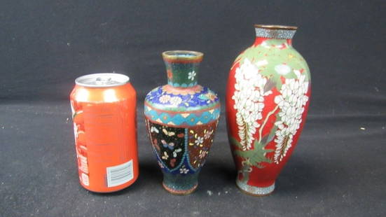 Pair of Old Chinese Cloisonne Vases: A pair of old Chinese cloisonne vases; Beautiful detailing on both vases; The blue vase is decorated with many different panels of flowers and also has a butterfly detailing; The red vase is