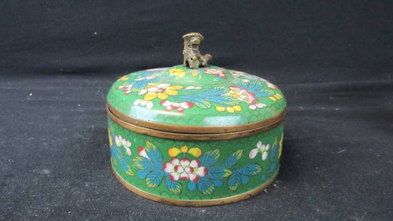 Old Antique Chinese Cloisonne Jewelry Box: An antique Chinese cloisonne jewelry box with a foo dog sitting on the top as a handle; Features an exquisitely detailed floral pattern on a green background; The foo dog sits on the lid