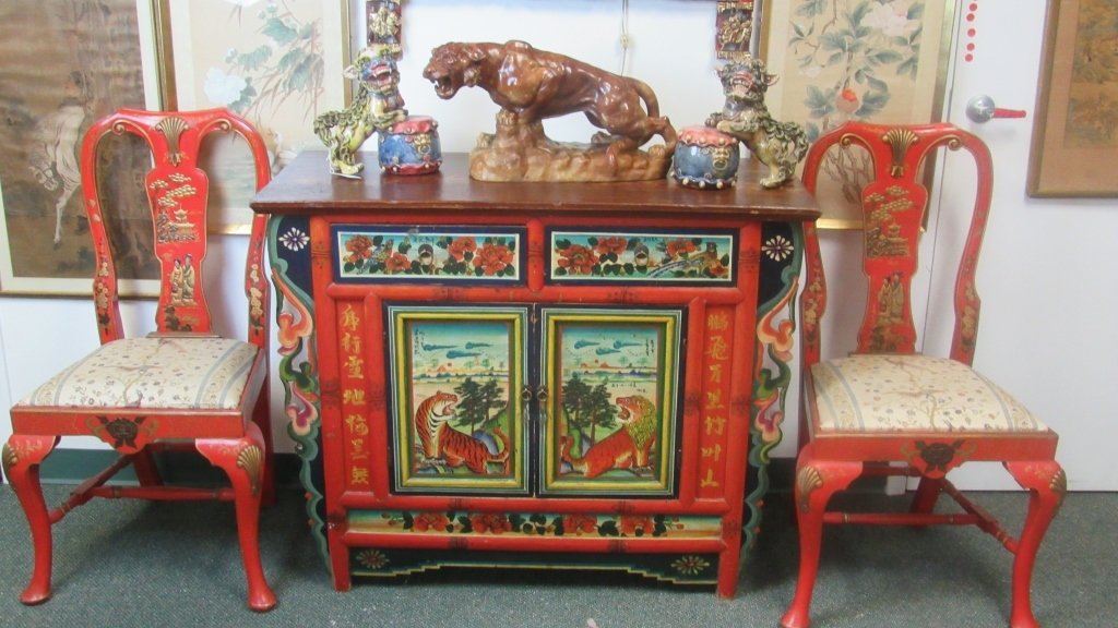 Chinese Painted Cabinet Table & Chairs: Beautifully painted and decorated Chinese cabinet table and pair of chairs. Table design details include a lion, tiger and many floral details and chinese characters. Chairs are red and gold with cust