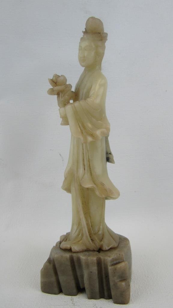 Jade Carved Figurine: Qing Dynasty carved jade figurine of a woman holding a flower. on a soapstone base. 7.25: x 2.25"