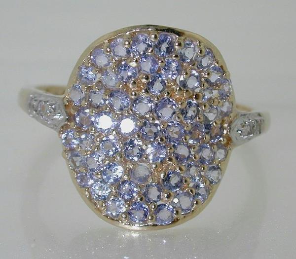 1.5 CT DIA AND TANZANITE RING: THIS IS A 10 KT YELLOW GOLD DIAMOND AND TANZANITE RING WITH A TOTAL WEIGHT OF 3 GRAMS. THE RING CONTAINS 1.5 CT OF DIAMOND AND TANZANITE. THE RING IS A SIZE 10. Circa: Contemporary Size: 10