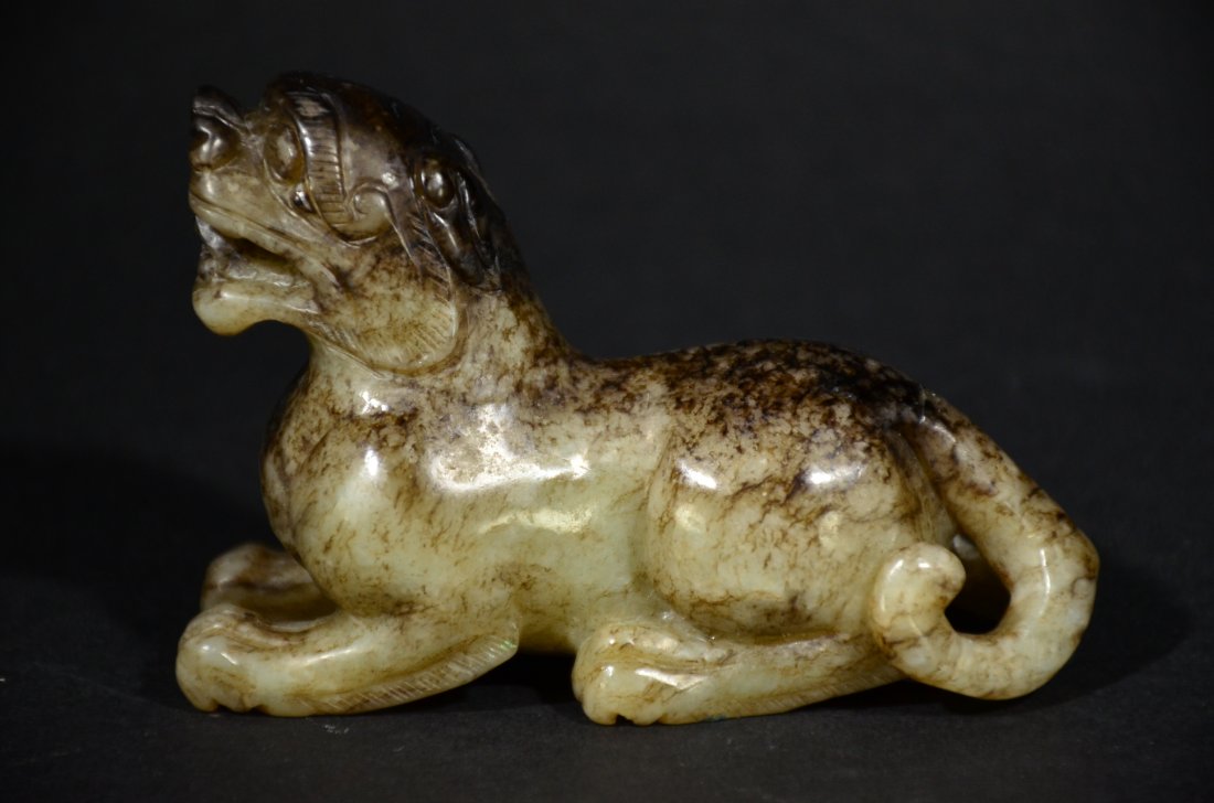A CARVED JADE TIGER ORNAMENT WITH SKIN (1 of 7)
