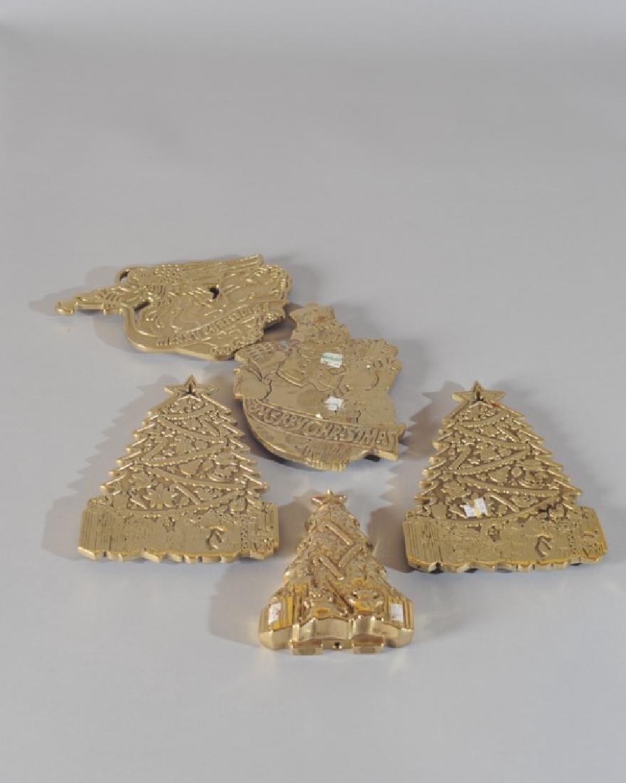 Five Virginia Metalcrafters Christmas Trivets: Two are "The Christmas Tree" (Third Christmas Trivet dated 1997), "The Christmas Angel" (Fifth Christmas Trivet), "The Snowman" (Fourth Christmas Trivet), a 1998 shaped Christmas tree. Largest: approx