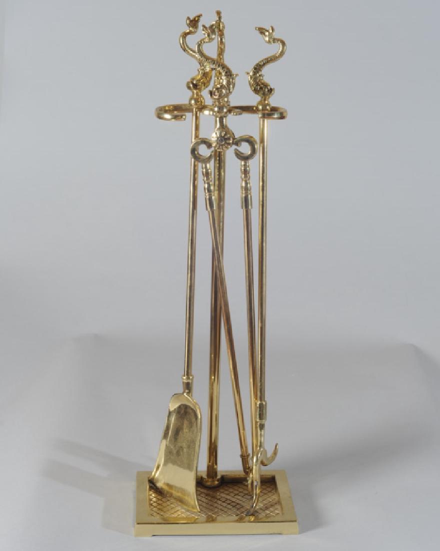 Brass Fireplace Tool Set: Three pieces with dolphin handles in a dolphin handled holder. H: approx. 32".
