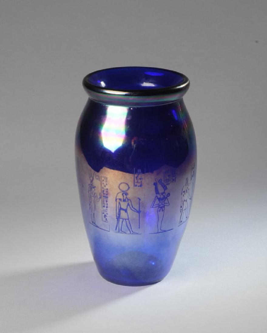 David Gruenig Art Glass Vase: Blown, blue iridescent vase with etched Egyptian motif, signed "Gruenig". H: approx. 8 3/4".