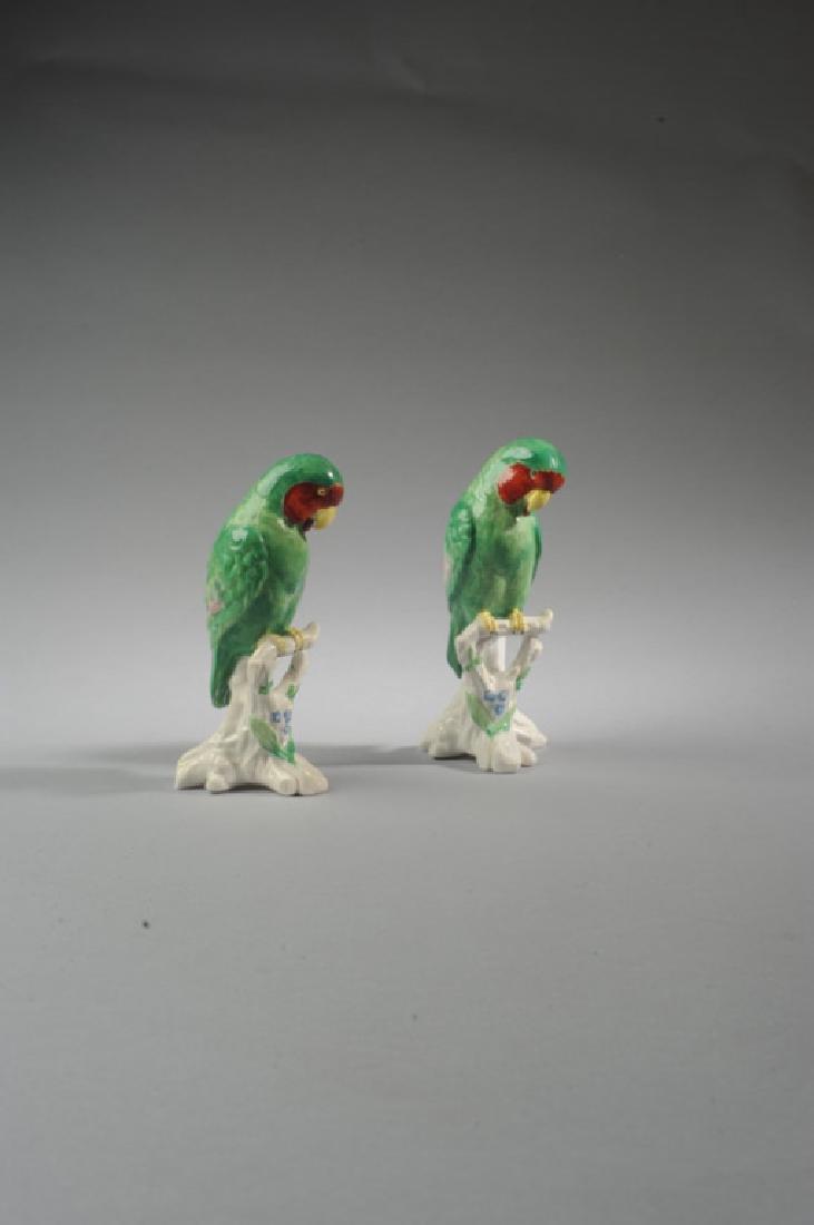 Pair of Copeland Spode Parrots: Featured on branches, one with missing eyes (eyes have fallen into head), signed "Spode Copelands China England" to base. H: approx. 5 3/4". Provenance: From a prominent Central Virginia manor house.