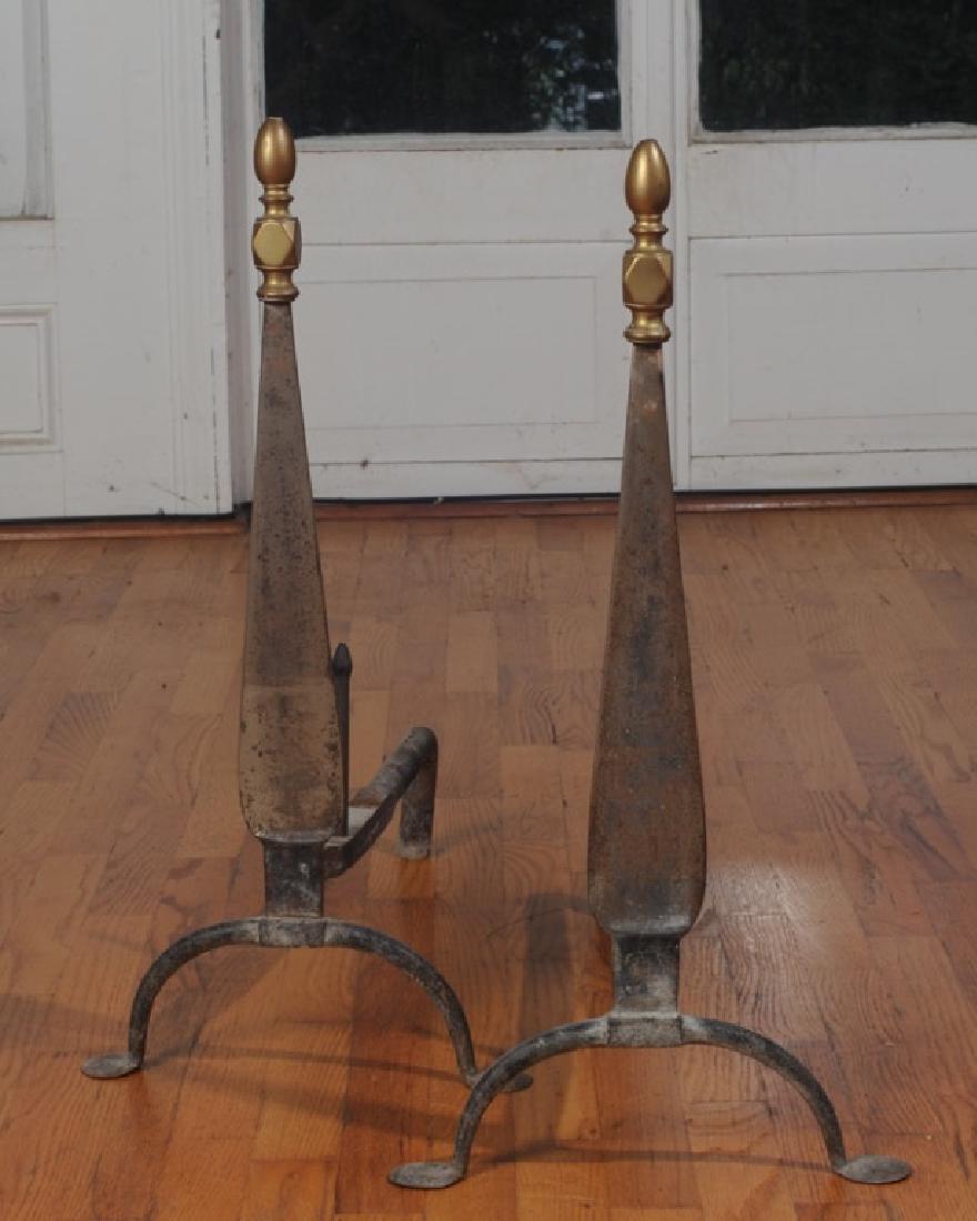 Pair of Brass and Cast Iron Andirons: Stylized brass urn finial. Provenance: From a prominent Central Virginia manor house. H: approx. 26".