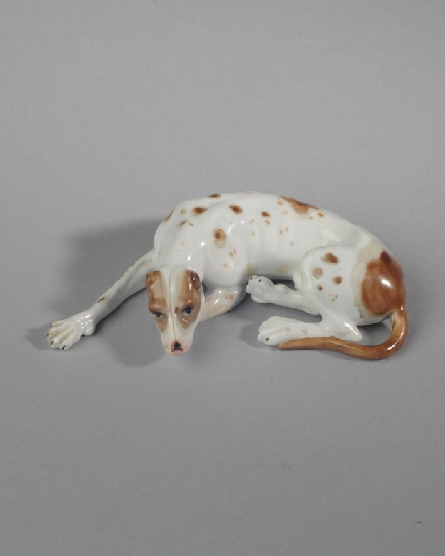 Continental Porcelain Dog Figure: In totally relaxed mode, missing one paw. Provenance: From a private Central Virginia collection belonging to the descendants of British Brigadier General Sir William Thomas Francis Horwood. L: approx