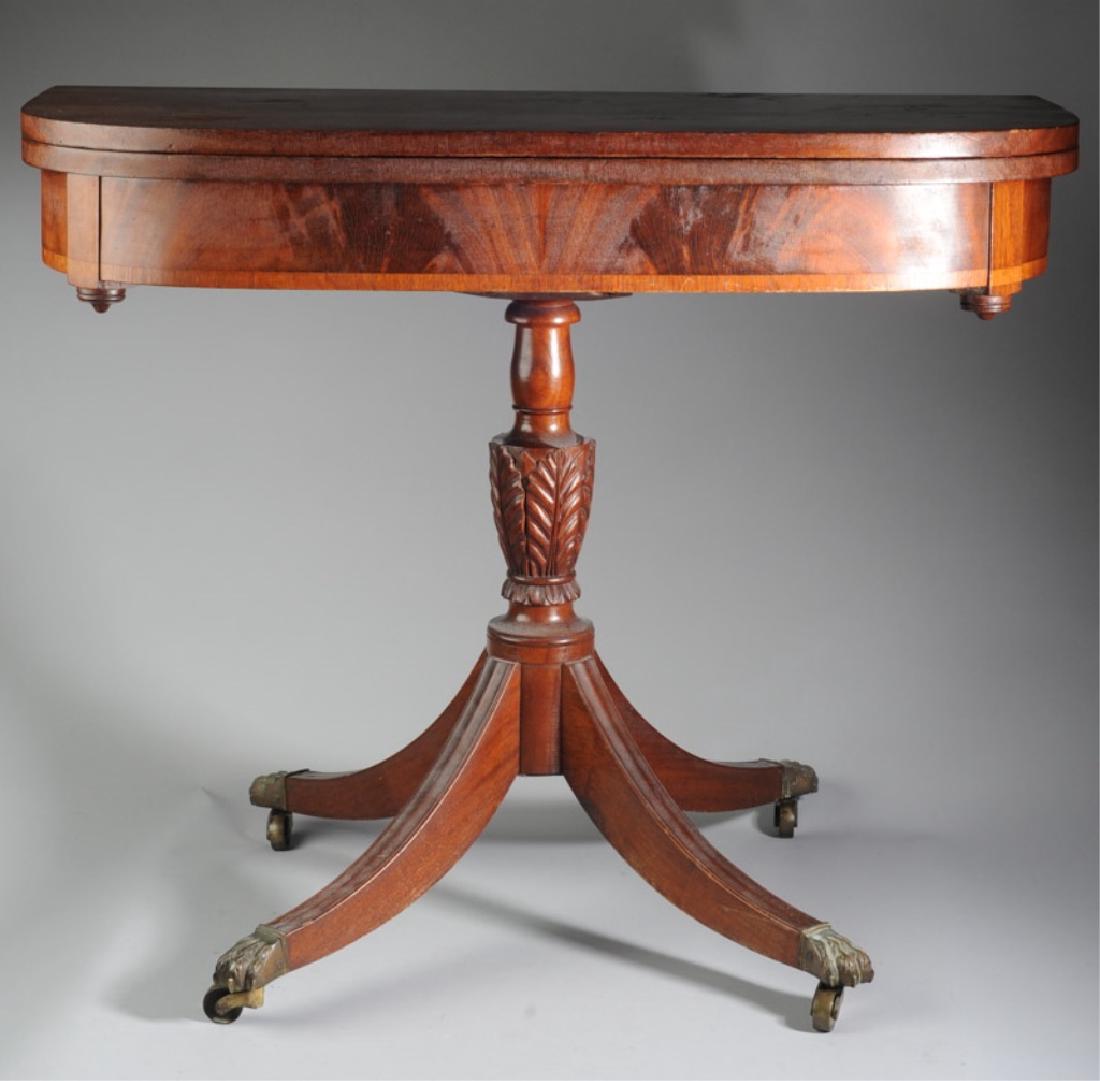 19th C. Duncan Phyfe Style Gaming Table: Probably mahogany, possibly New York State, well carved leaf motif pedestal, dovetailed construction, four shaped legs terminating in brass claws on casters, metal support to base. Baring an early han