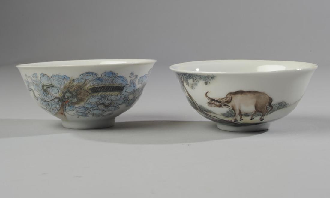 2 Chinese Republic Nanchang Zodiac Bowls: Charmingly painted pair of Republic period bowls from a set of zodiac animals. This pair shows a dragon and an ox in famille rose enamels. Red six character mark to base identifies a Nanchang artist a