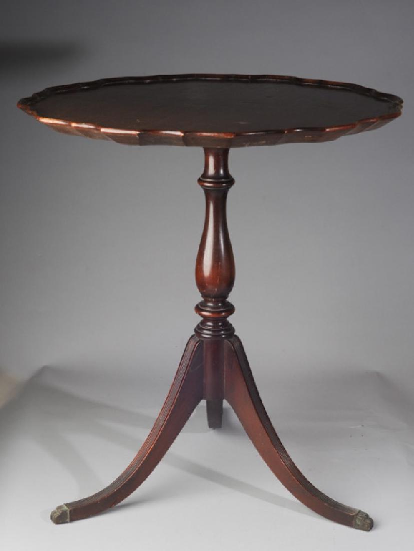 Duncan Phyfe Style Occasional Table: Three reeded legs terminating in brass claw feet, Ferguson Bros. Mfg. Co. New Jersey label to underside, sculptural border. H: approx. 27". Dia: approx. 24".