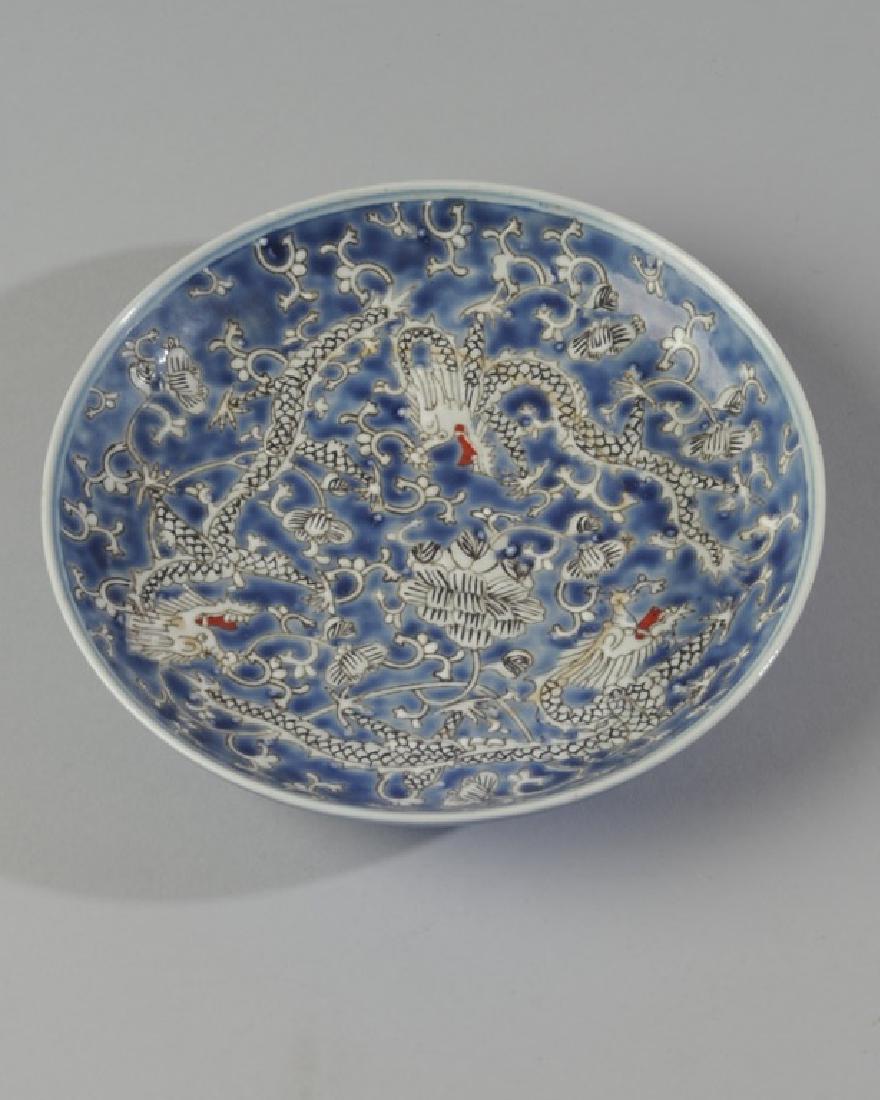 Chinese Enamel Powder Blue Dragon Plate: With decoration of writhing dragons, monochrome blue underside. Six-character Kangxi mark in underglaze blue within double circle to base. probably early 20th century.