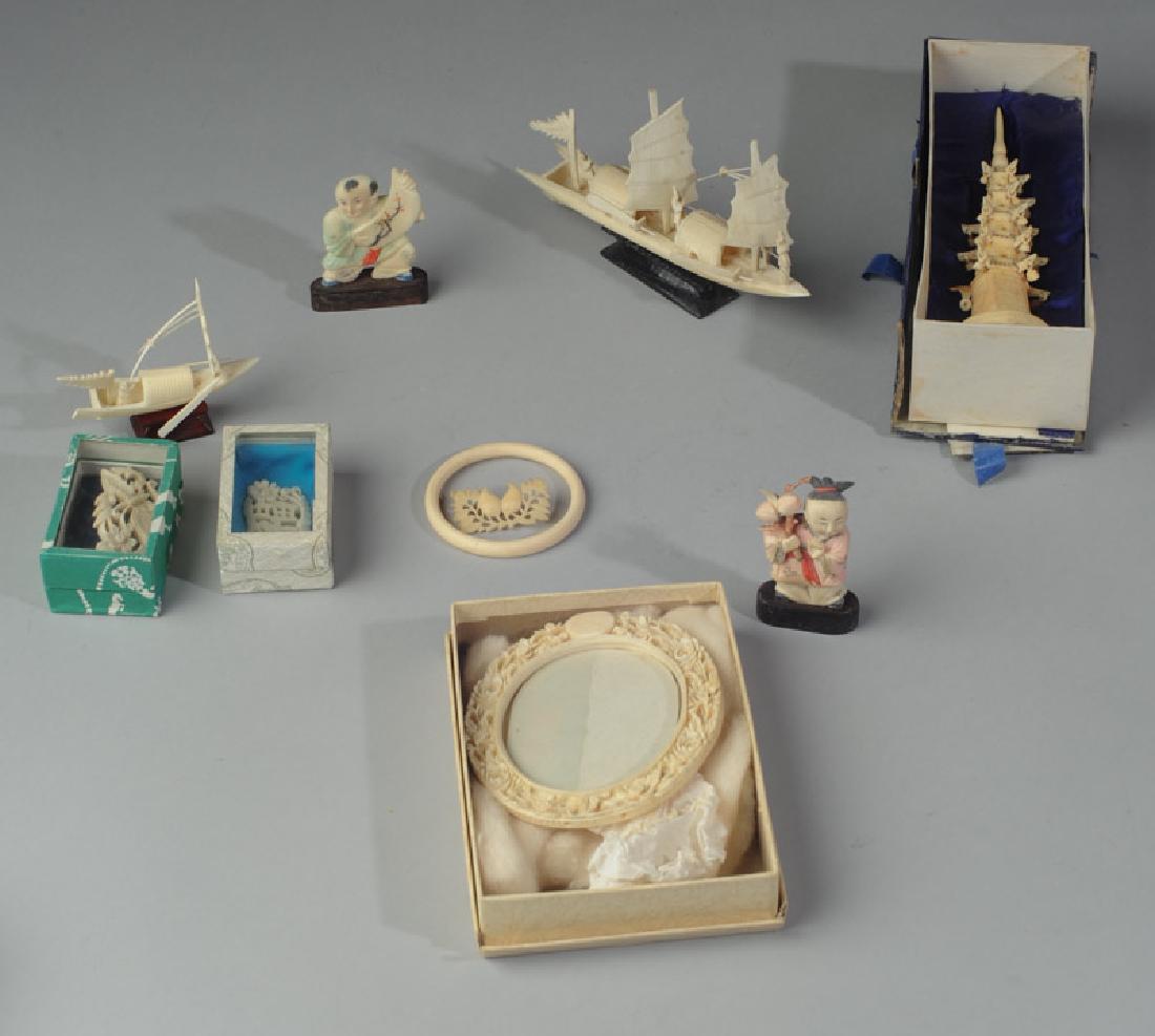 Lot Vintage Chinese Carved Bone or Resin Trinkets: To include model pagoda, three brooches, oval picture frame, child-sized bracelet,a large and a small carving of a junk ship, and figures of two children. Pagoda is aprox 7" in height.